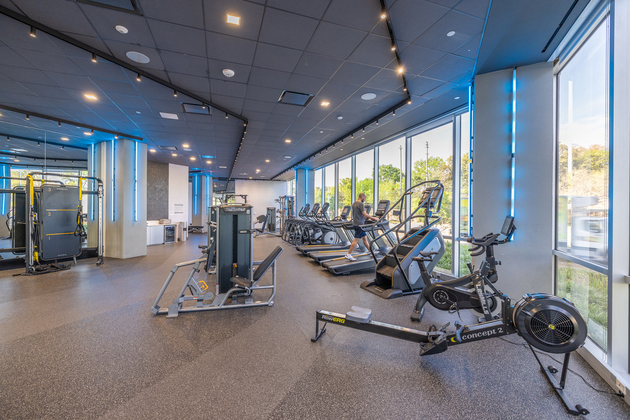 Fitness center at 800 Gessner Road with rowing machines, exercise bikes and glass walls