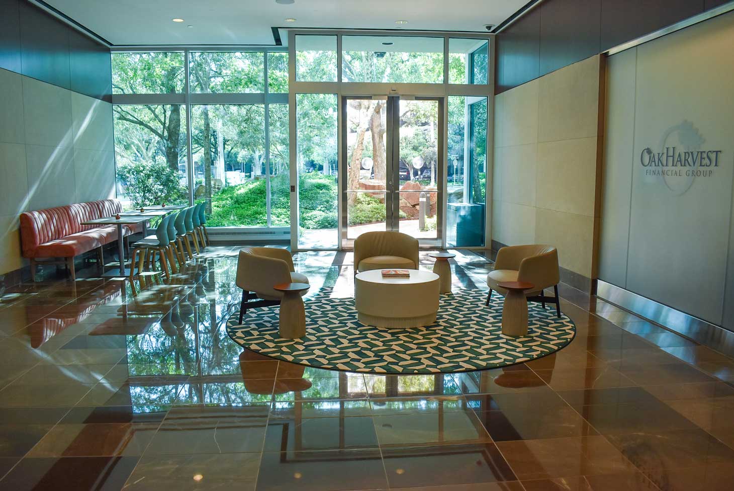 Cafe lounge at 920 Memorial City Way with a patterned floor and a glass wall looking out to greenery