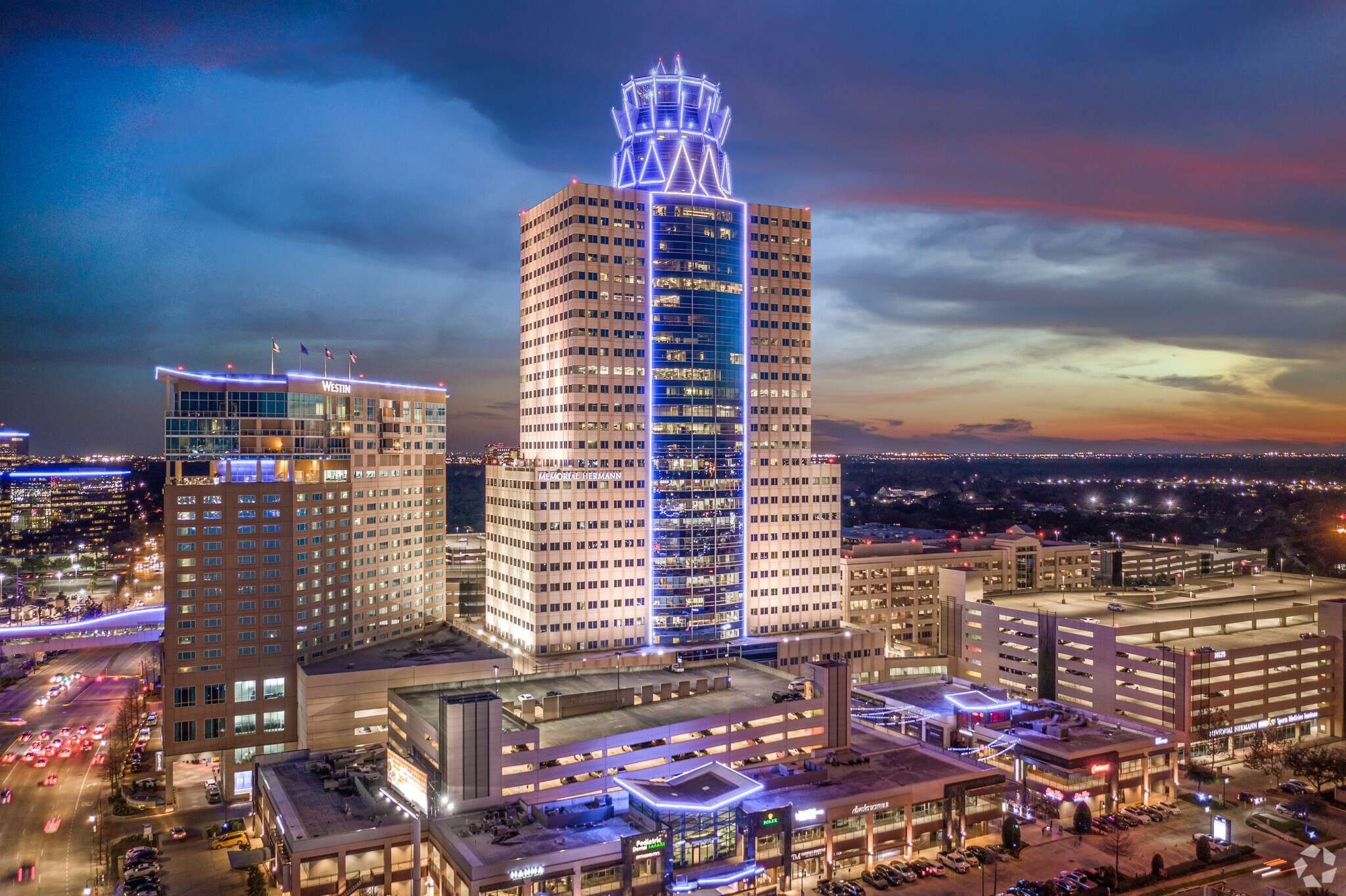 Memorial Hermann Tower at 929 Gessner Road lit at night above the Memorial City district