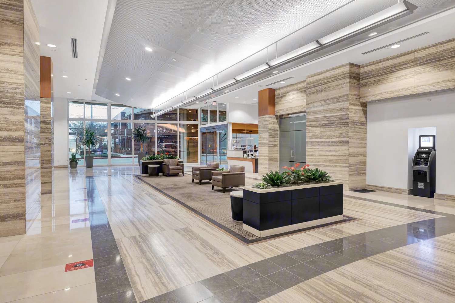 Reception and security desk in the lobby of 929 Gessner Road, with a digital building directory