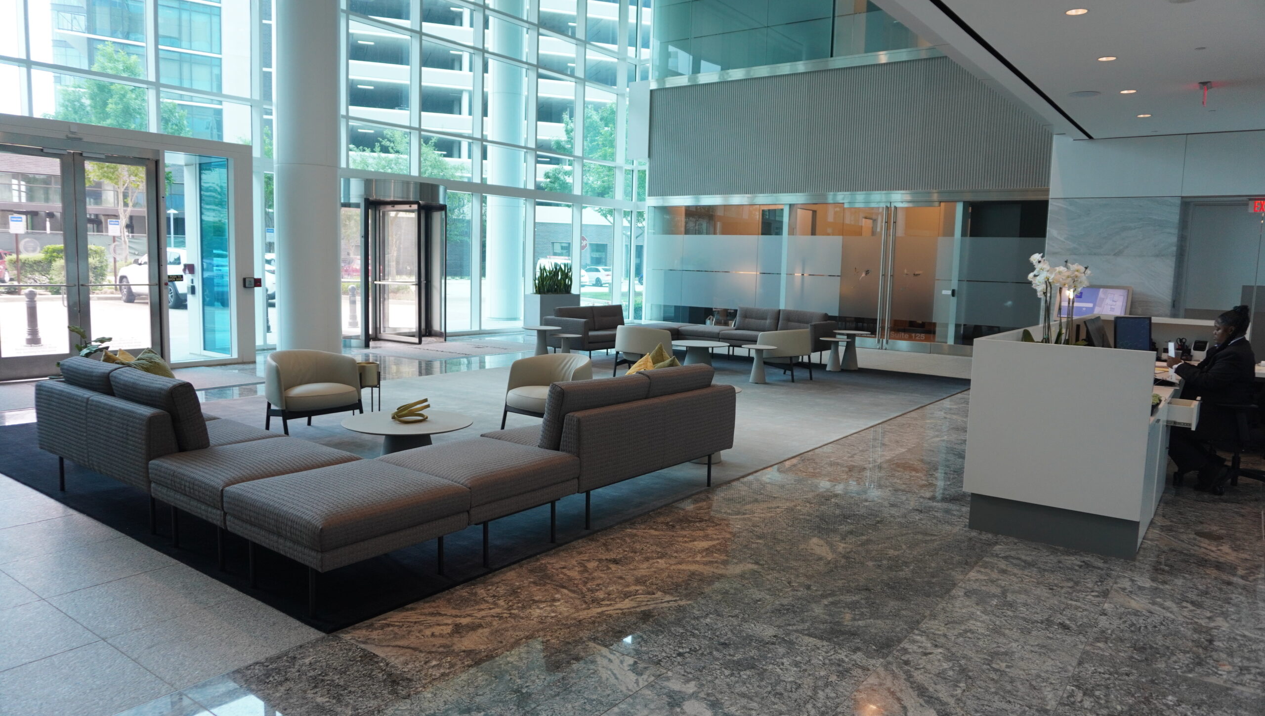 Lobby lounge at 945 Bunker Hill Road with sofas and glass walls looking out to neighbouring towers