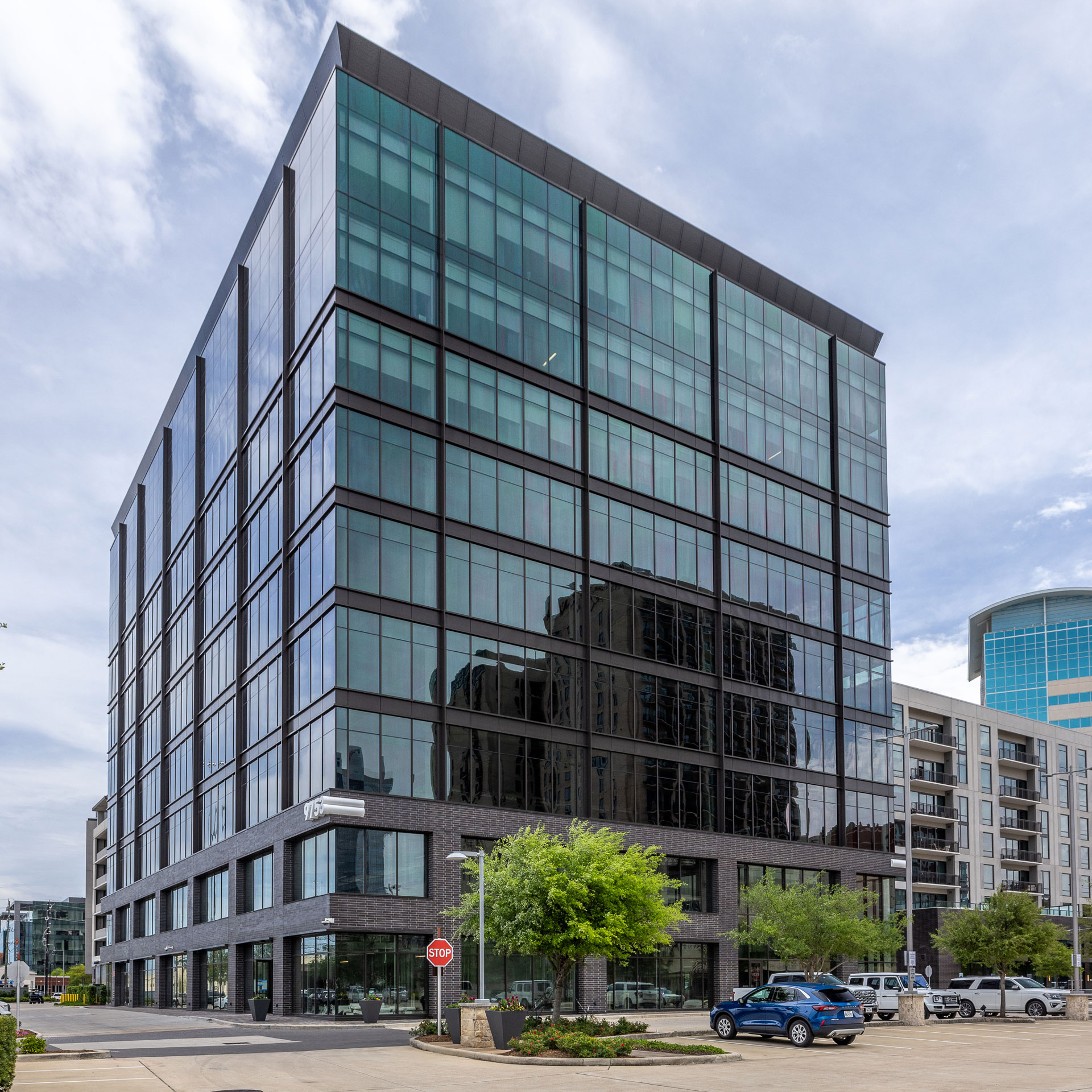 Exterior of the dark glass and stone office building at 9753 Katy Freeway