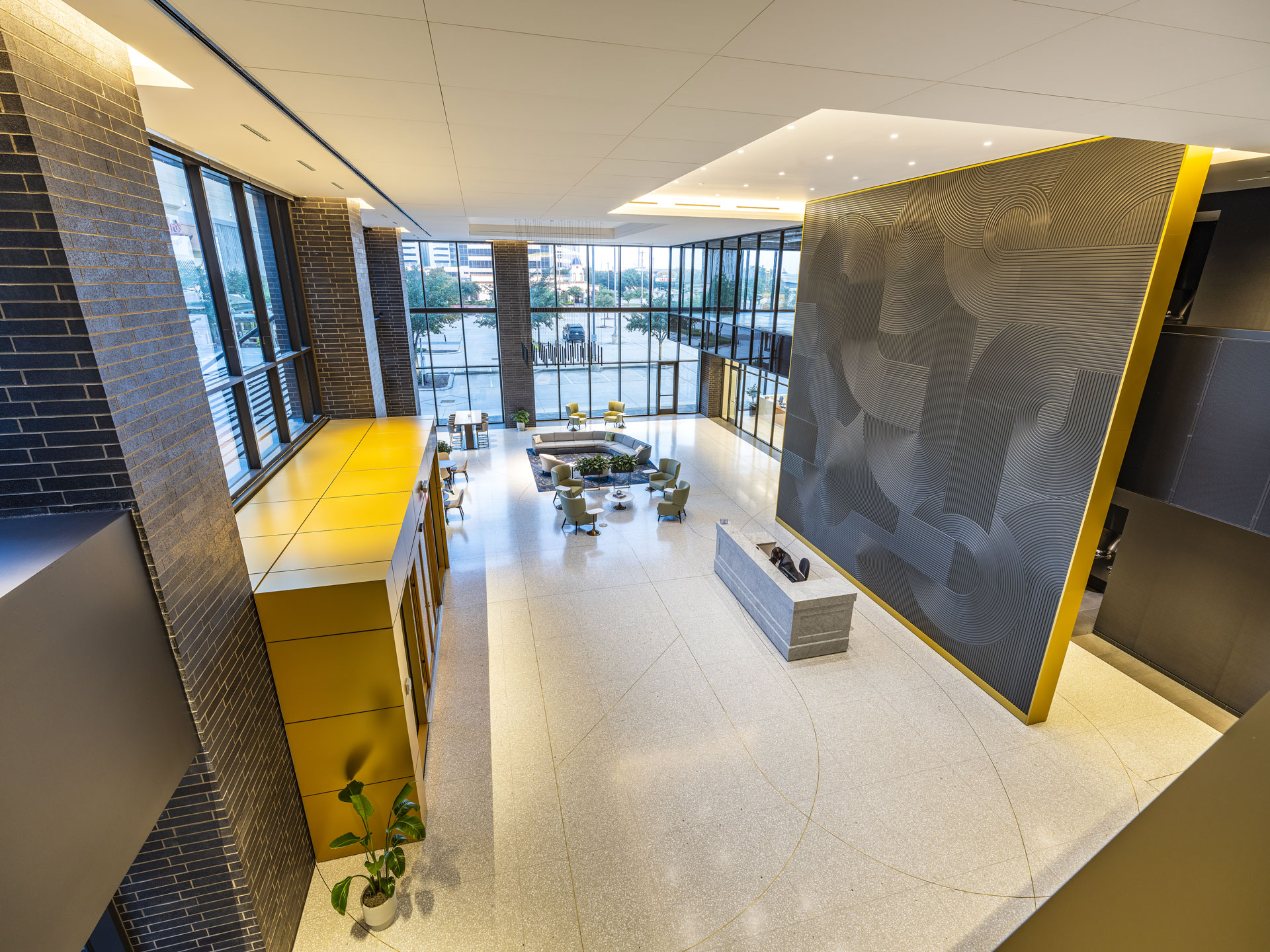 Lobby at 9753 Katy Freeway with a brass accent wall, textured dark panelling and seating by the windows
