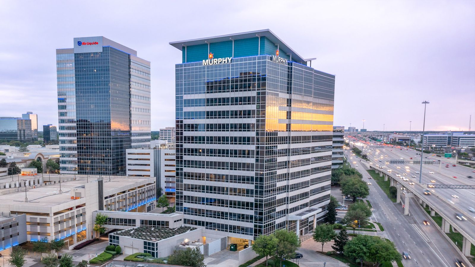Aerial view at dusk of the office towers along the Katy Freeway, including the Murphy Building at 9805