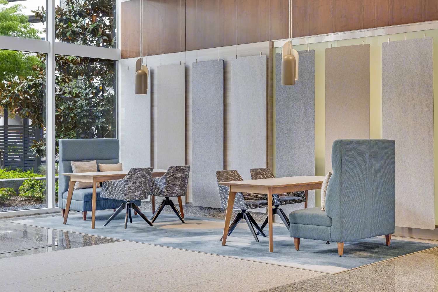 Lobby seating area at the Murphy Building with wood-panelled walls, cafe tables and armchairs