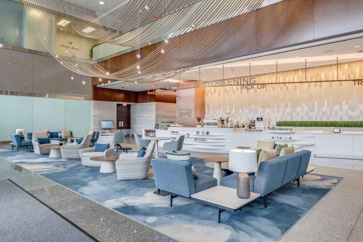 Lobby seating at the Murphy Building with armchairs, table lamps and a wood slat ceiling