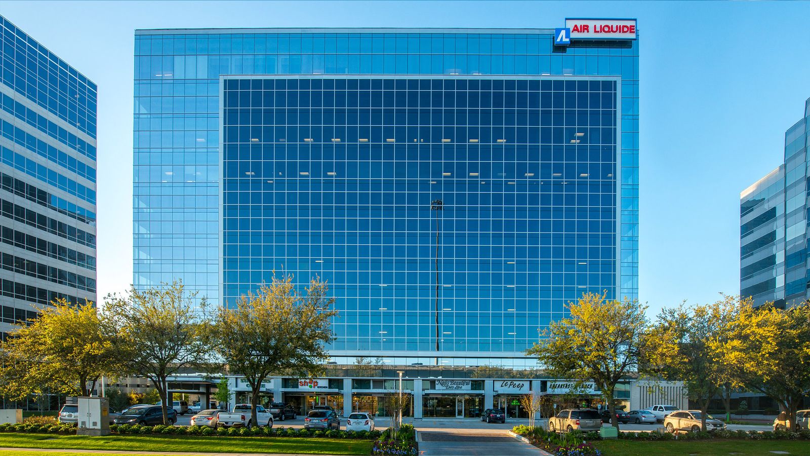 Exterior of Air Liquide Center North at 9807 Katy Freeway, a blue glass tower with the Air Liquide rooftop sign