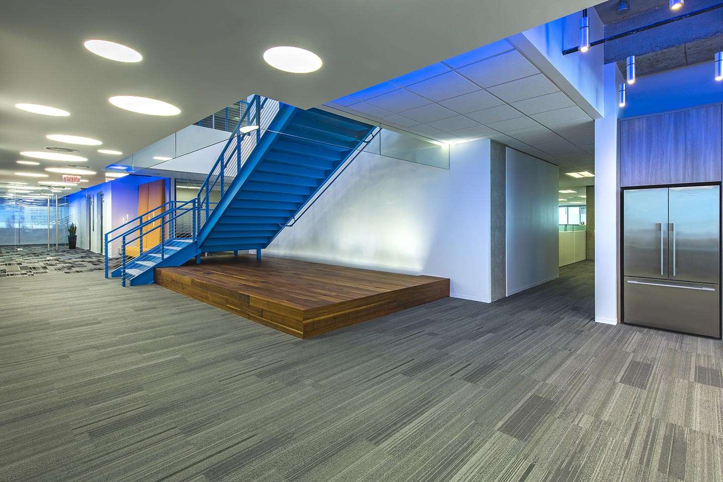 Lobby at Air Liquide Center North with a blue-lit staircase and a wood bench