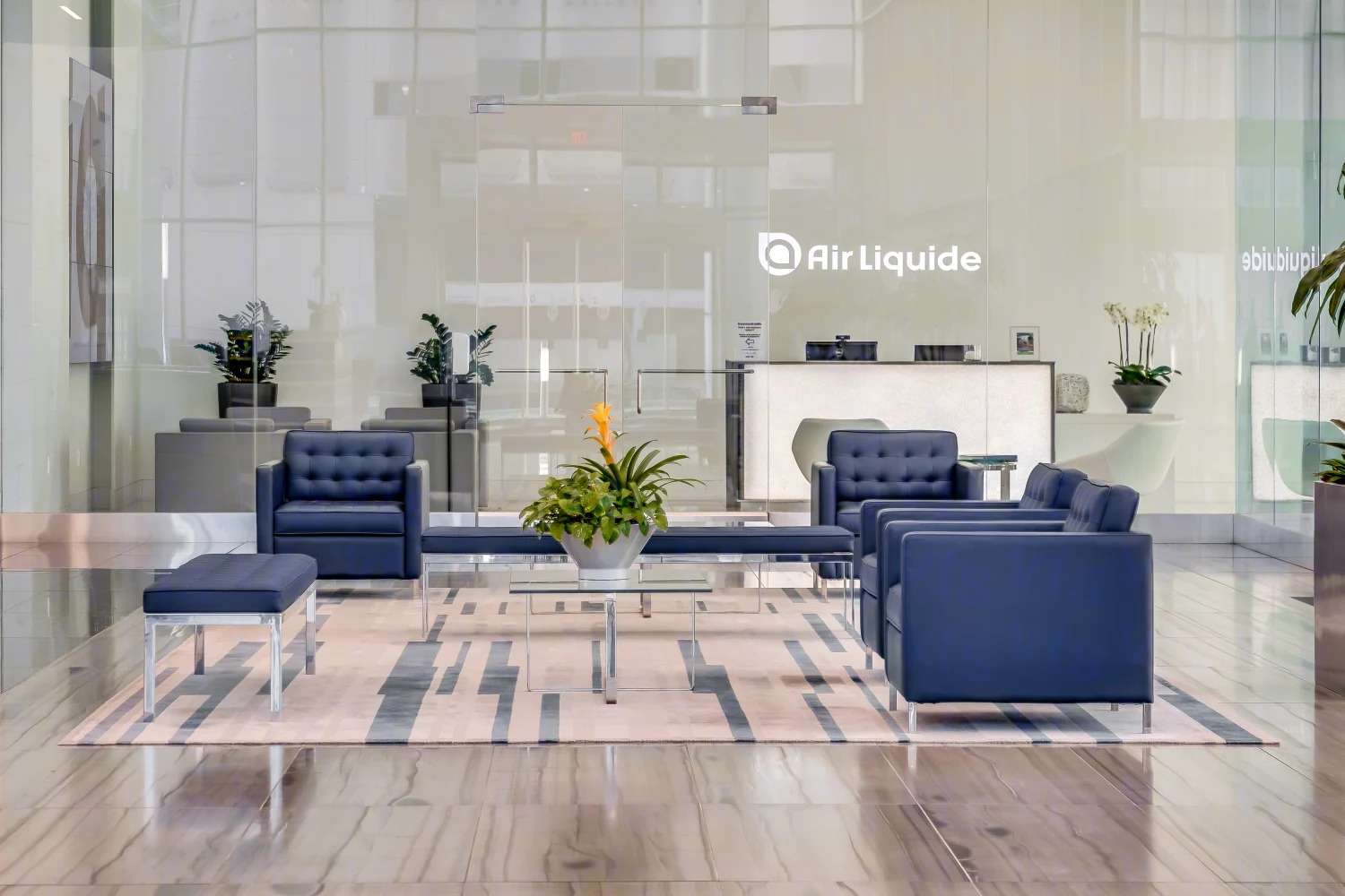 Air Liquide reception area with navy sofas and the company name on the wall