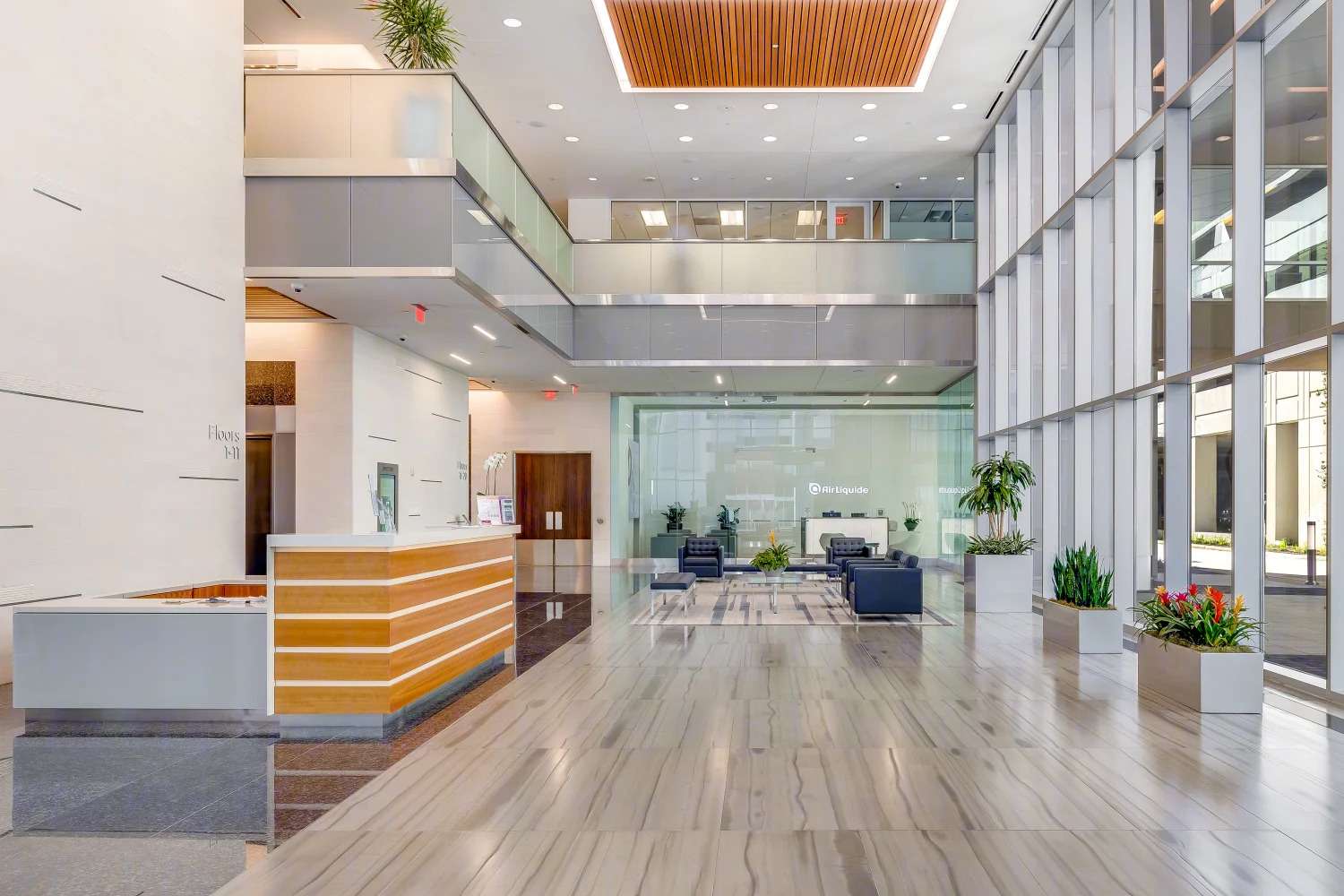 Lobby at Air Liquide Center South with a wood reception desk and glass walls to the seating area