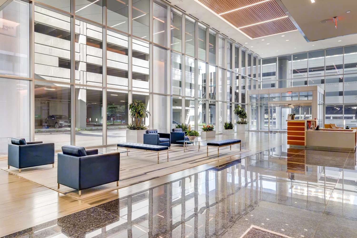 Lobby at Air Liquide Center South with dark armchairs, columns and a reception counter