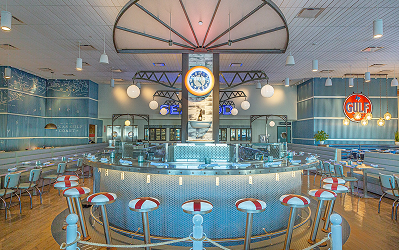 Goode Retro diner interior at Goode Co. Seafood in Katy Retail Centers, with a curved light blue counter and life rings on the walls