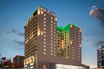 Hotel ZaZa Memorial City at dusk, lit with green accent lighting