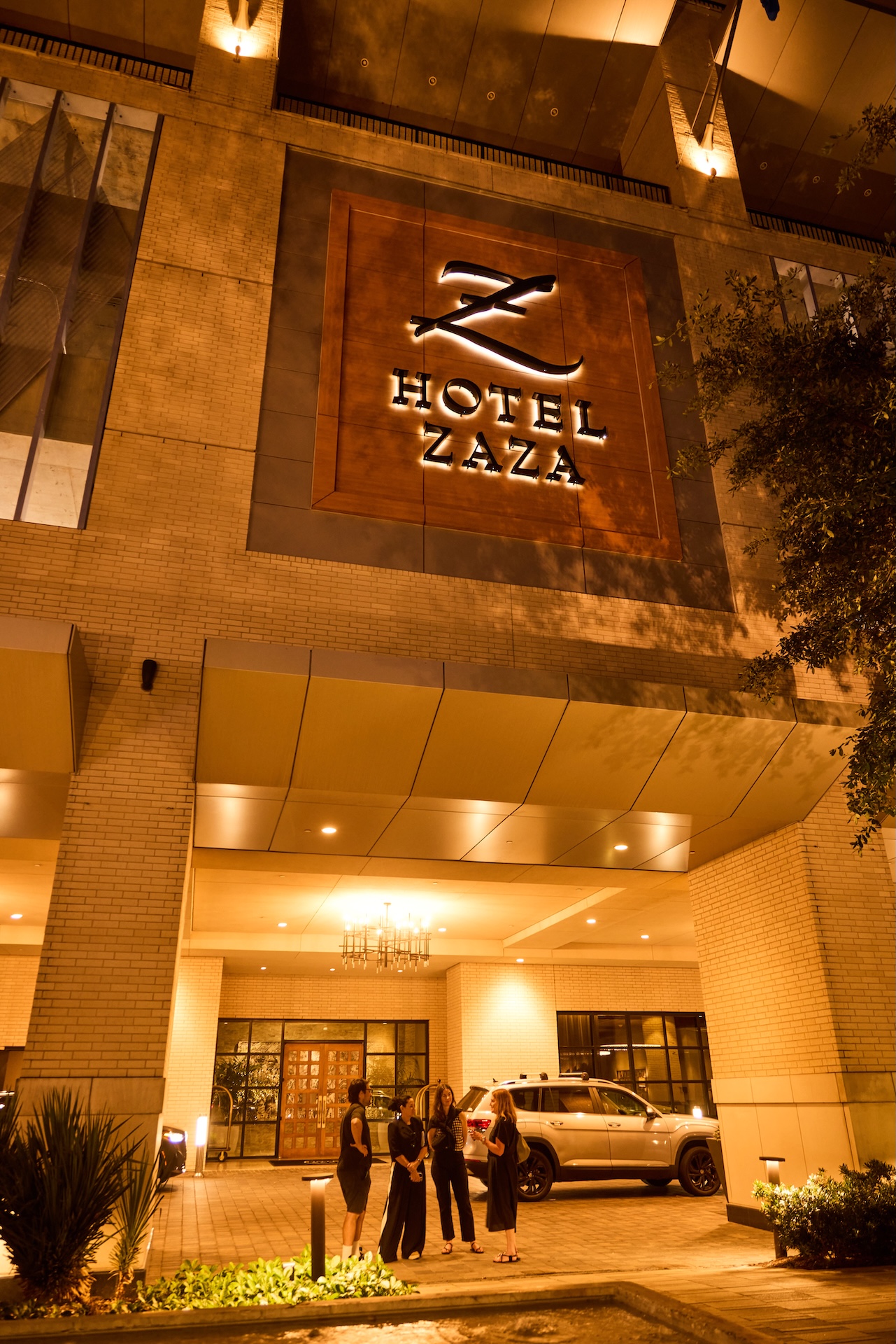 Entrance to Hotel ZaZa Memorial at night, with the illuminated Z sign above the porte-cochere