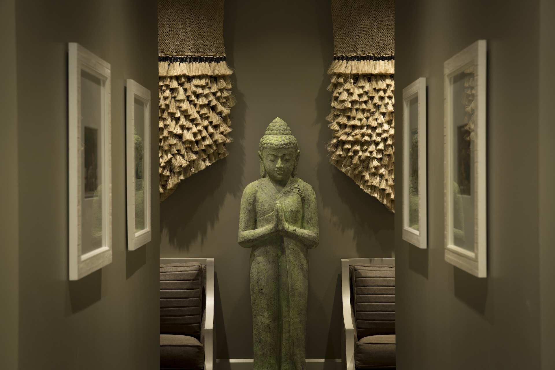 Corridor at ZaSpa in Hotel ZaZa Memorial with a carved stone Buddha statue