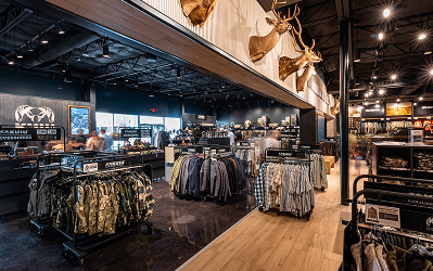Kuiu Interior of the KUIU hunting apparel store at Katy Retail Centers, with camouflage clothing on racks and mounted trophy mounts overhead