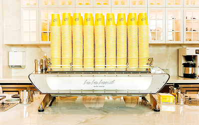 Rows of yellow bottled drinks displayed on a cafe counter at M-K-T Heights