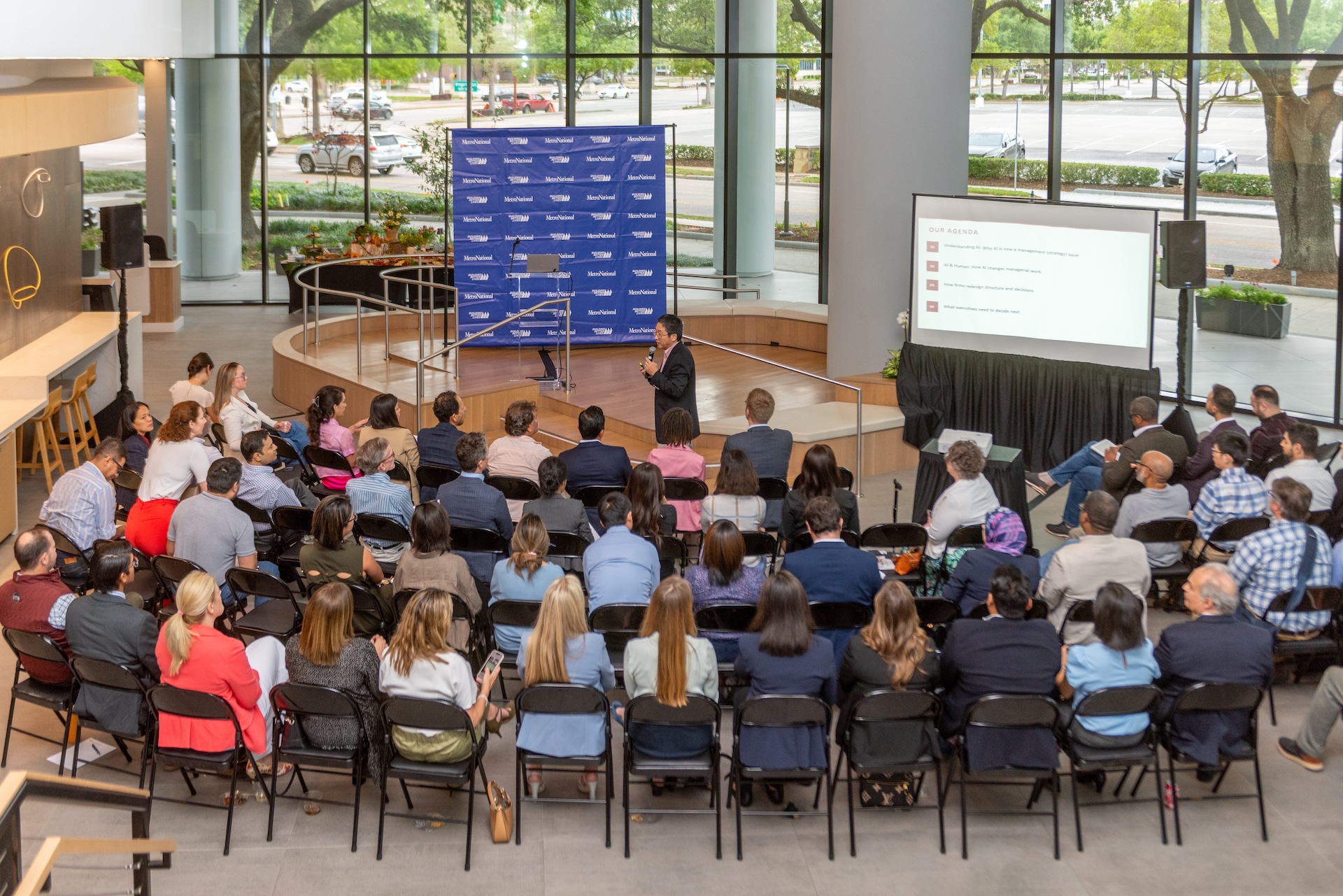 An audience seated for a presentation in a MetroNational lobby