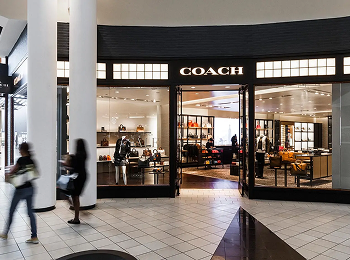 MCM03 Shoppers passing the Coach storefront inside Memorial City Mall