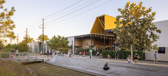 smfleming.com Street view of M-K-T Heights with its angular yellow canopy and people walking the promenade