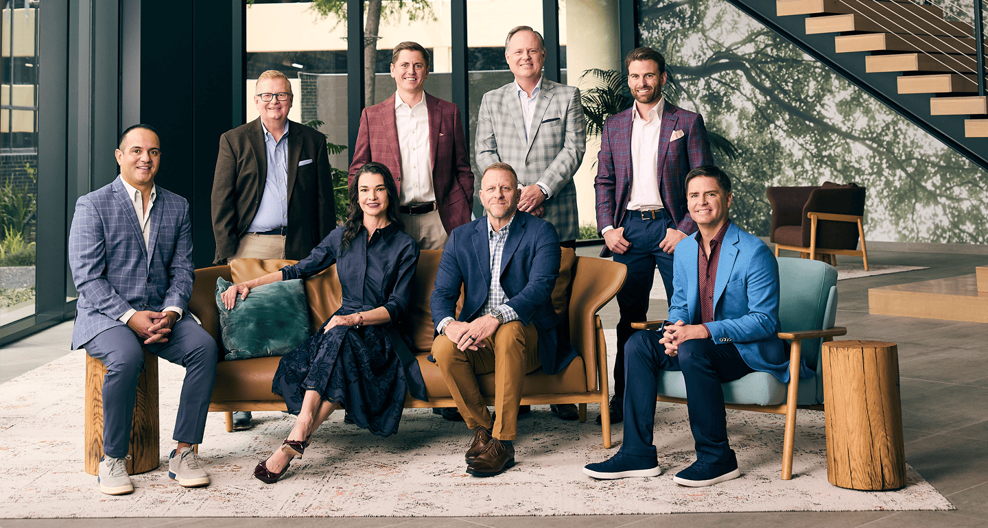 The MetroNational executive leadership team photographed together in a building lobby