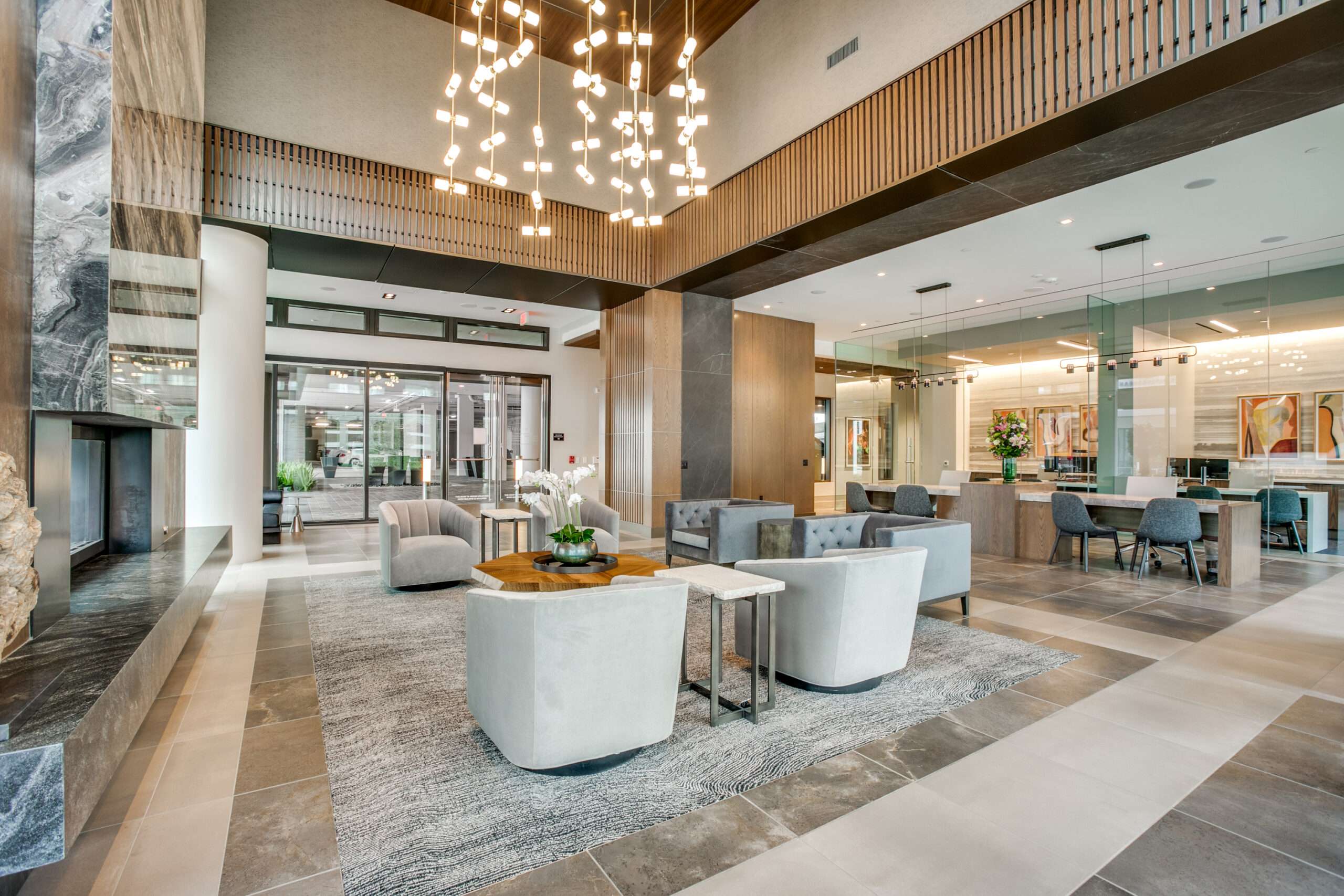 McKinley-06 Double-height lobby lounge at The McKinley with a chandelier and grouped seating