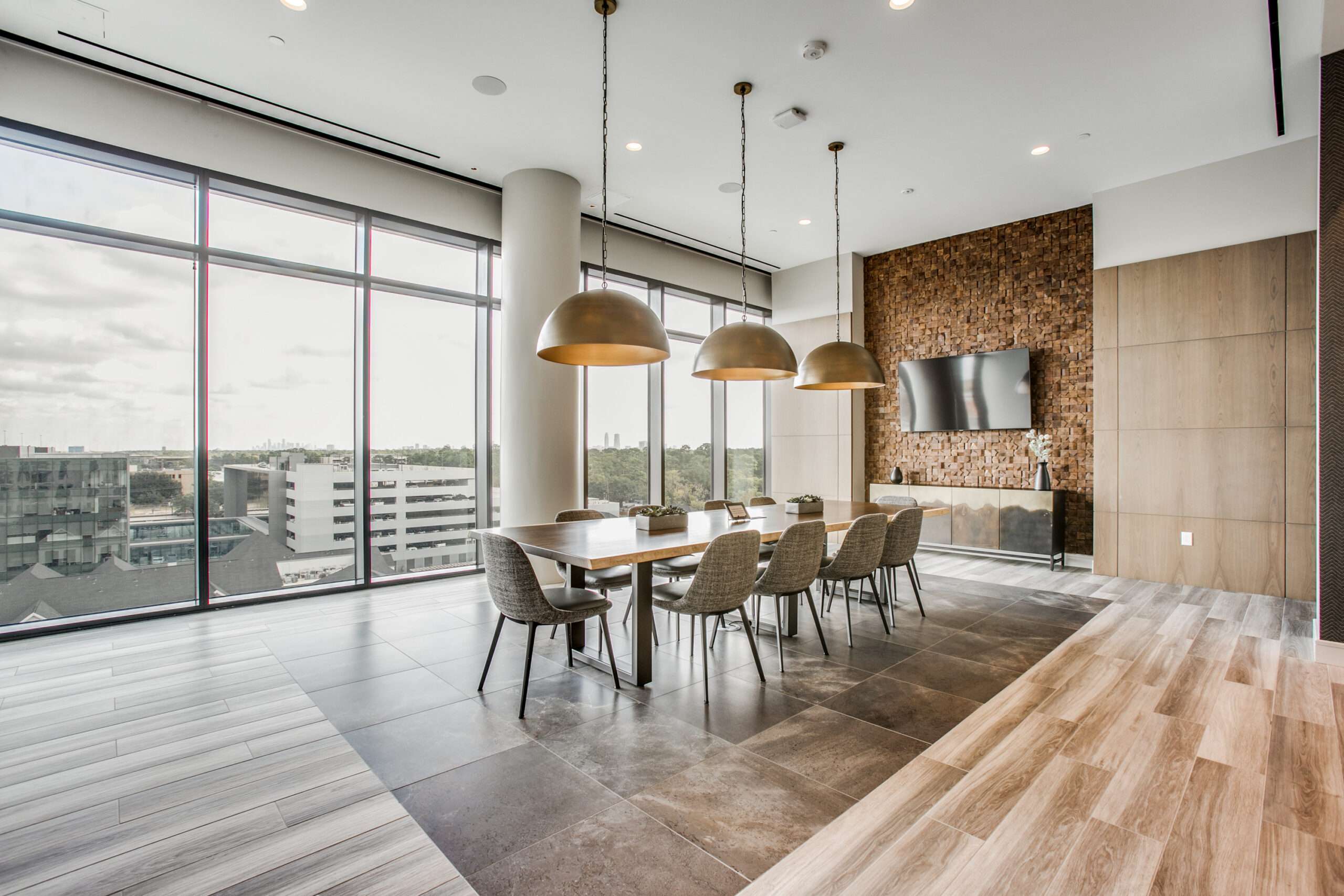 Dining area at The McKinley with pendant lighting and floor-to-ceiling windows
