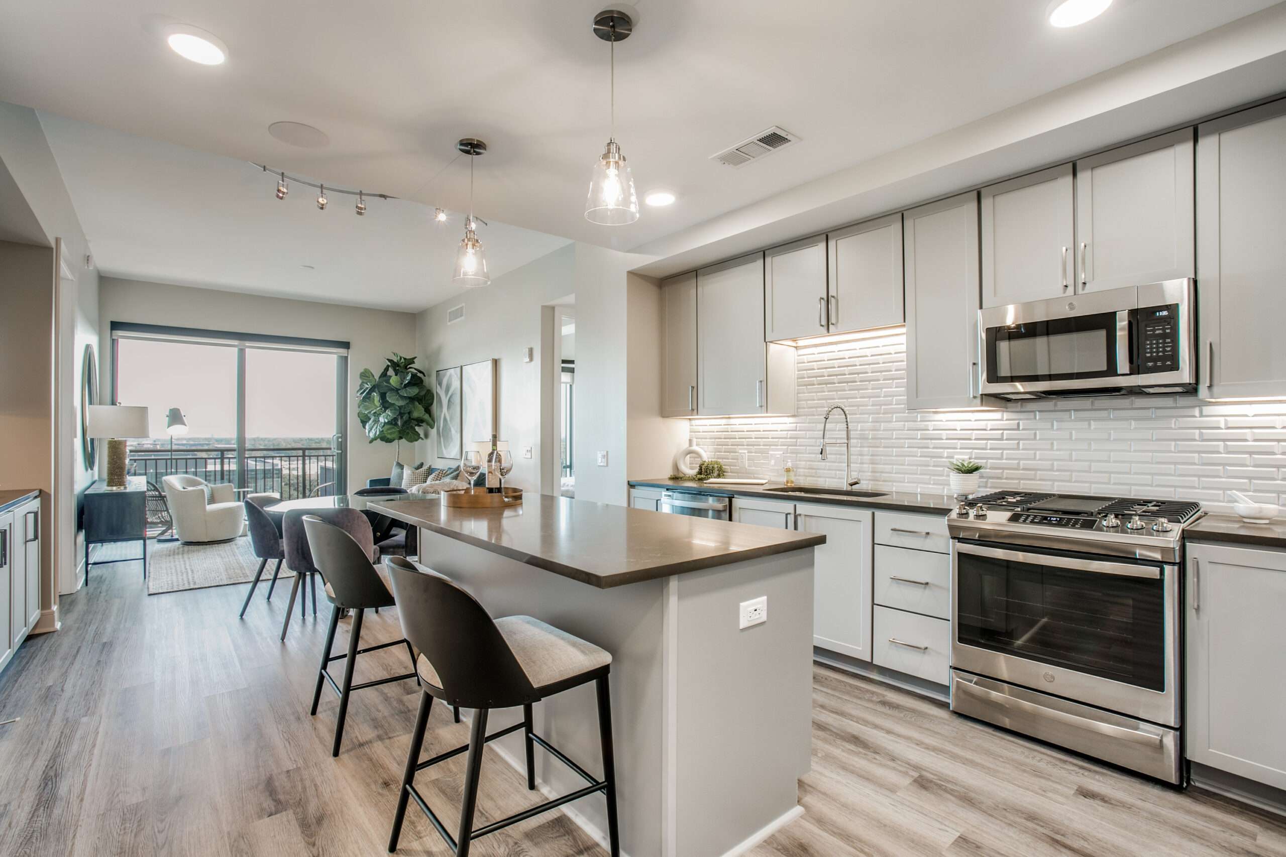 Apartment kitchen at The McKinley with an island, bar stools and stainless appliances