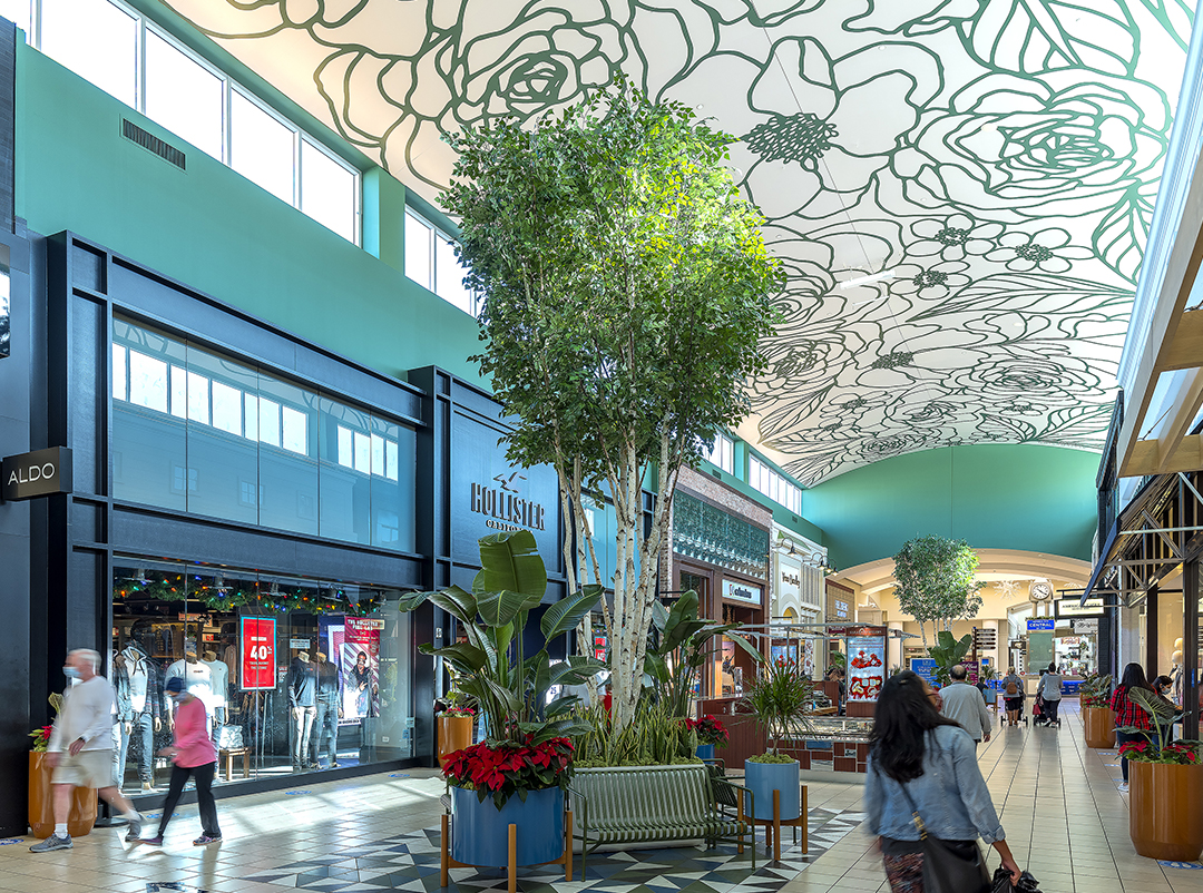 Mall concourse at Memorial City Mall beneath a decorative patterned ceiling canopy