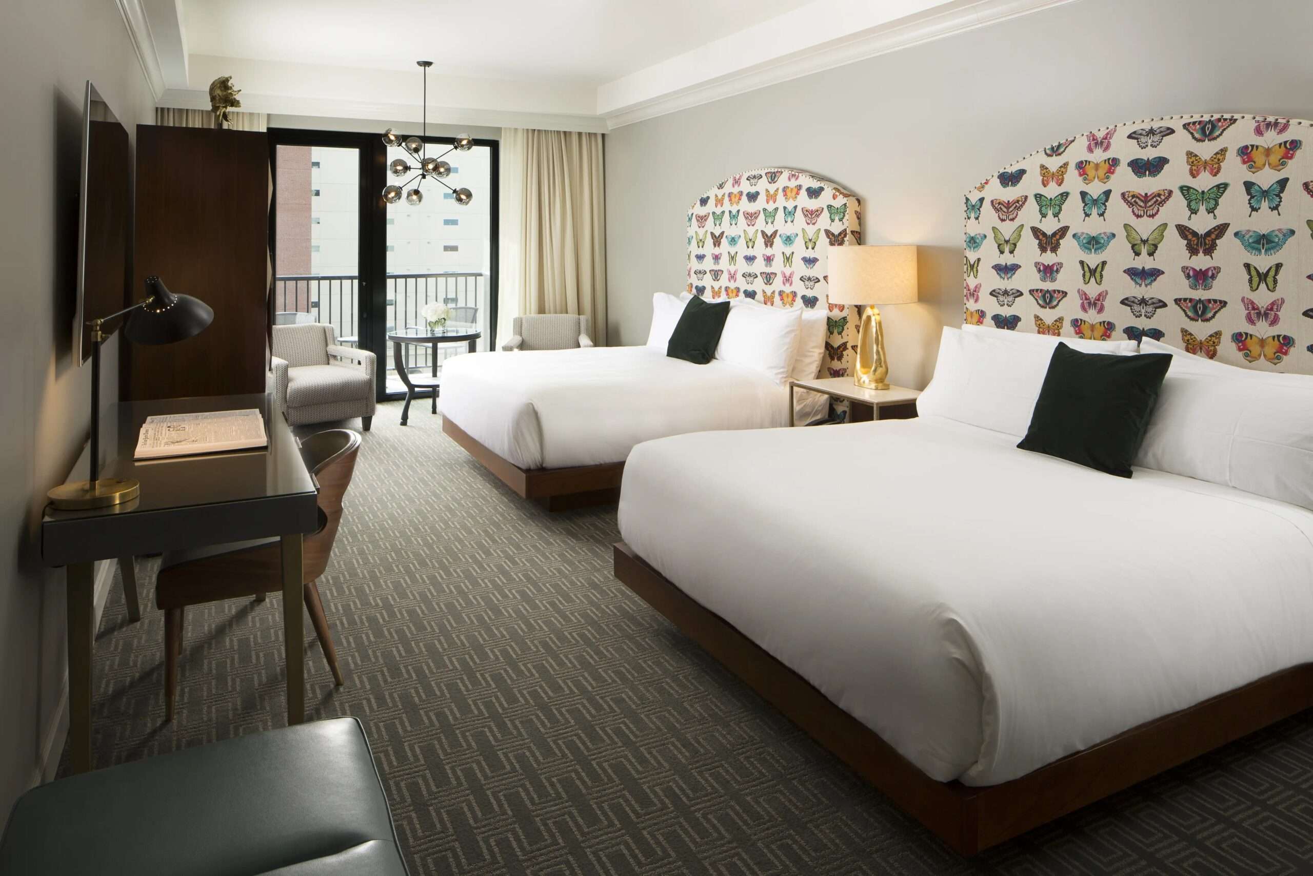 Double queen guest room at Hotel ZaZa Memorial with butterfly-patterned wallpaper