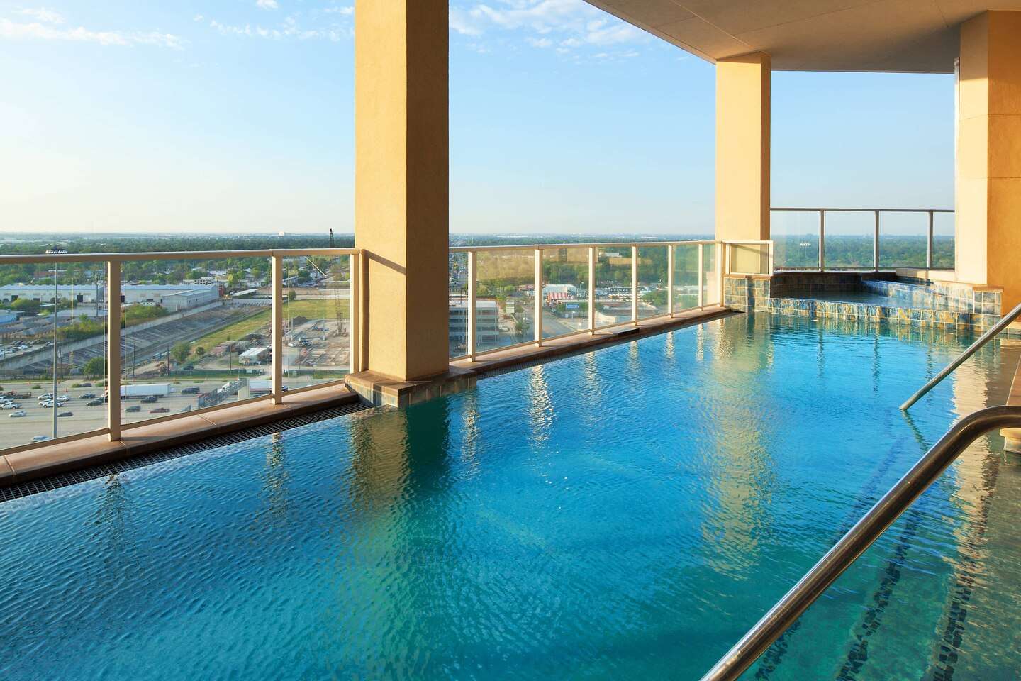 Memorial-The-Westin-04 Elevated outdoor pool at The Westin Memorial, framed by columns and overlooking the highway below