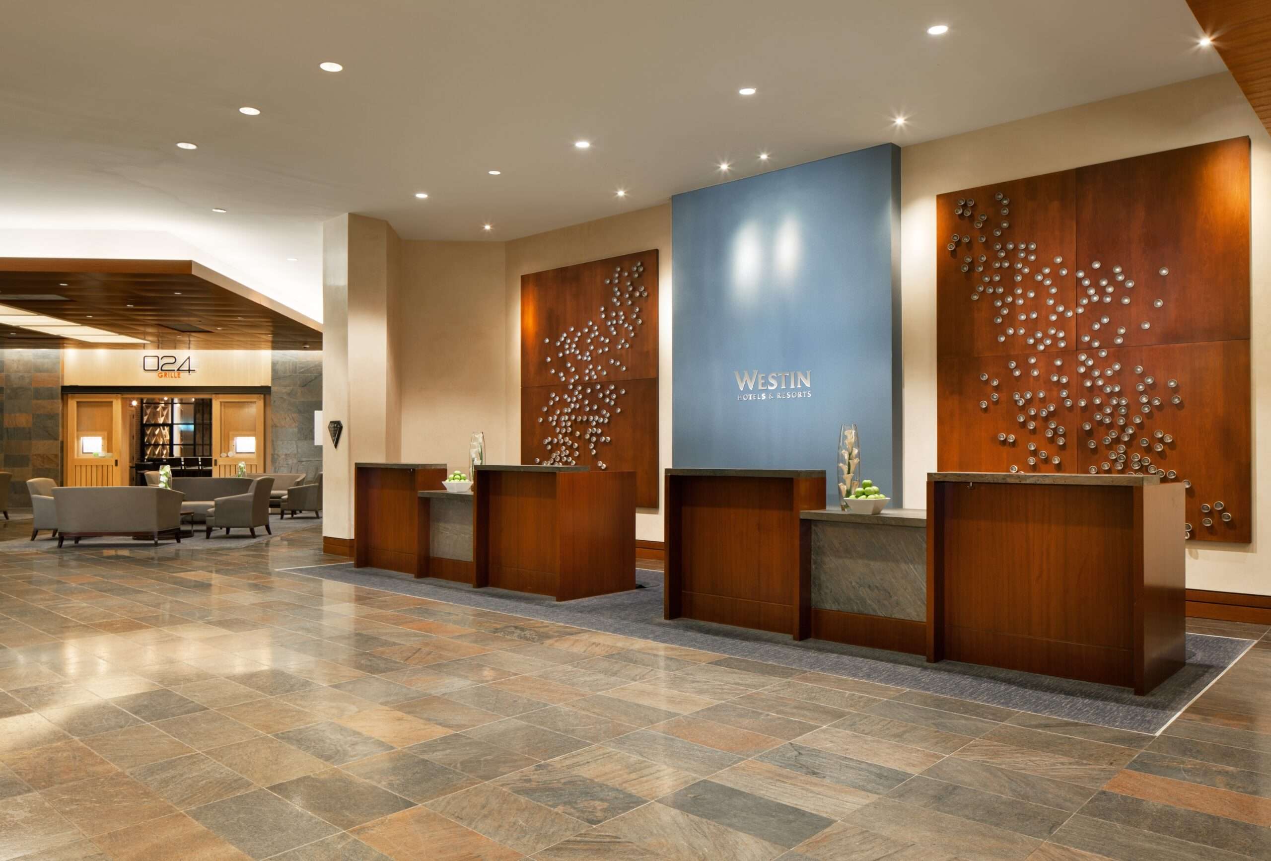Reception desk in the lobby of The Westin Memorial, with wood panelling and decorative wall art