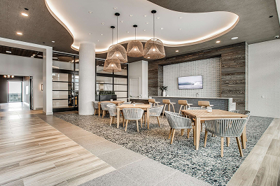 Multi-Family-CTA-New Leasing lounge with a curved ceiling, pendant lighting and a communal dining table