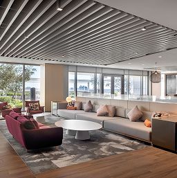 Office-For-Miles-Citycentre Office lounge at CityCentre with a sectional sofa, round coffee table and slatted ceiling