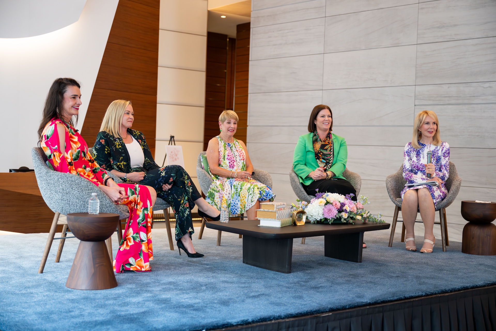 Five panellists seated on stage during a MetroNational speaker event