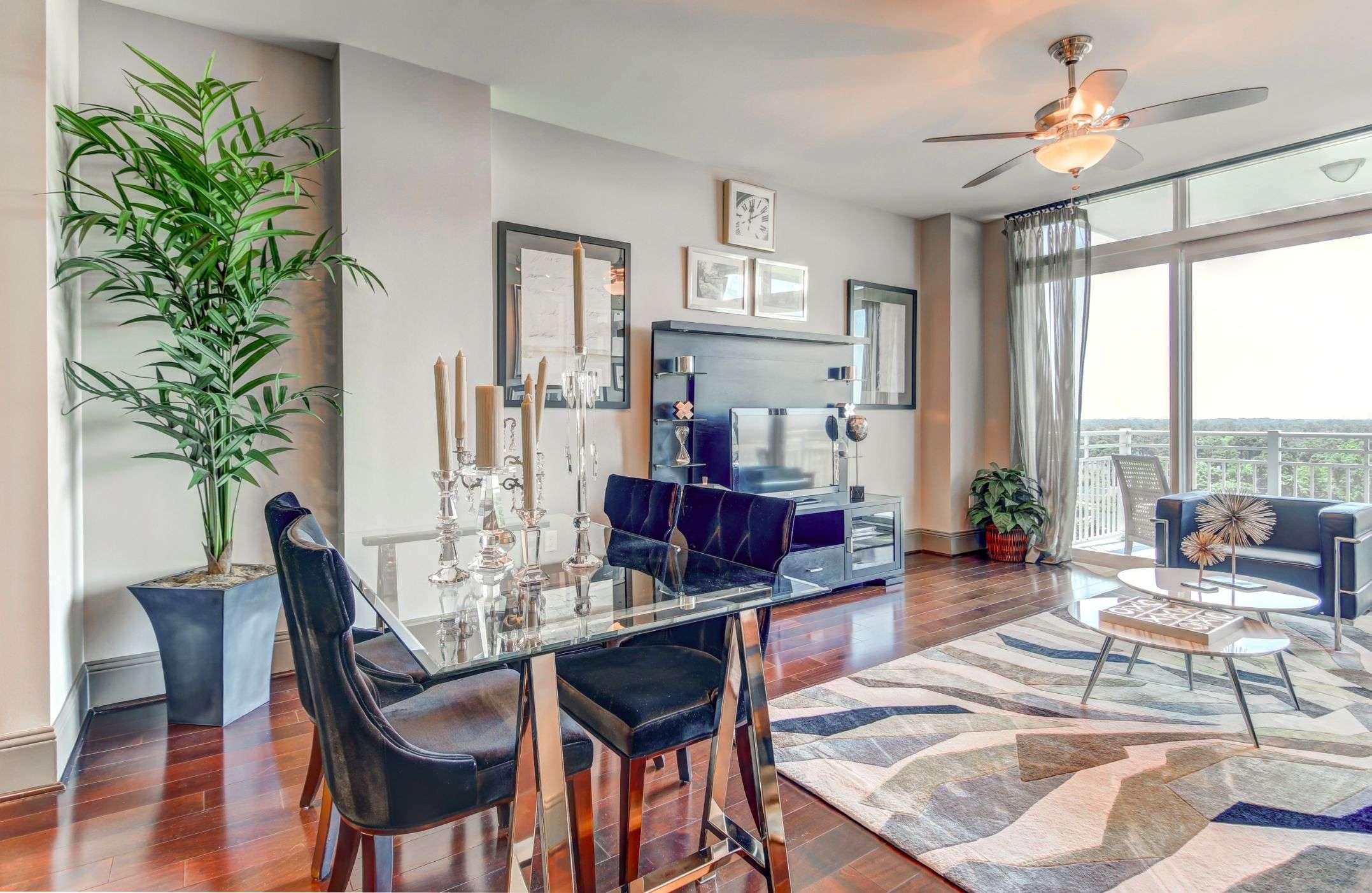 Living and dining area at The Fountains with a dining table and floor-to-ceiling windows
