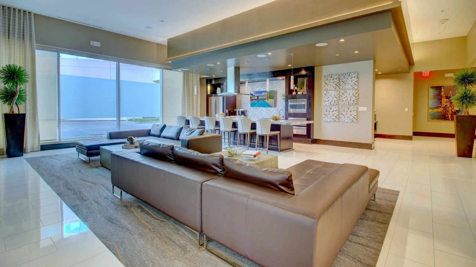Resident lounge at The Fountains with a large sectional sofa, coffee bar and potted plants