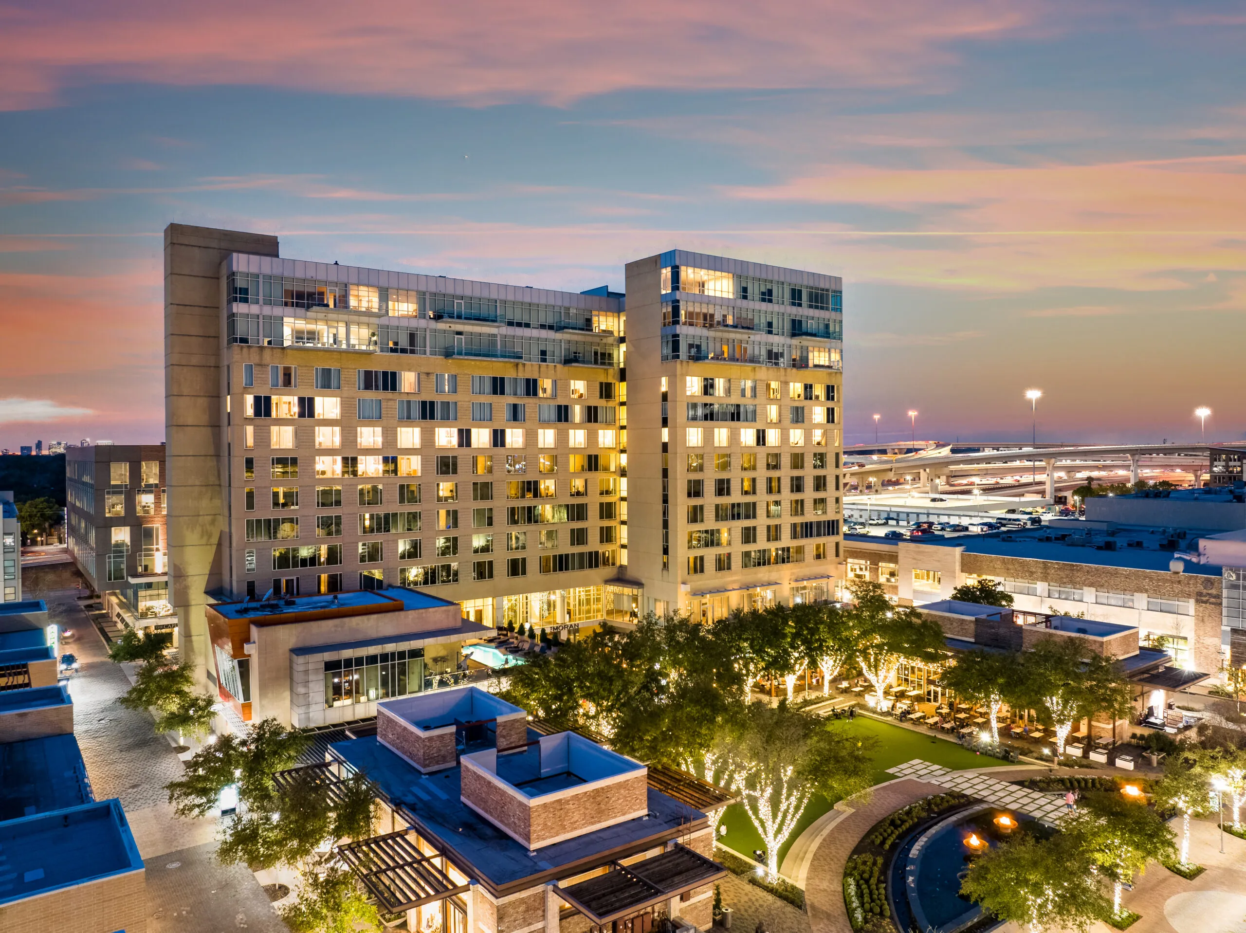 Aerial rendering of The Moran Hotel and its surrounding mixed-use development at sunset