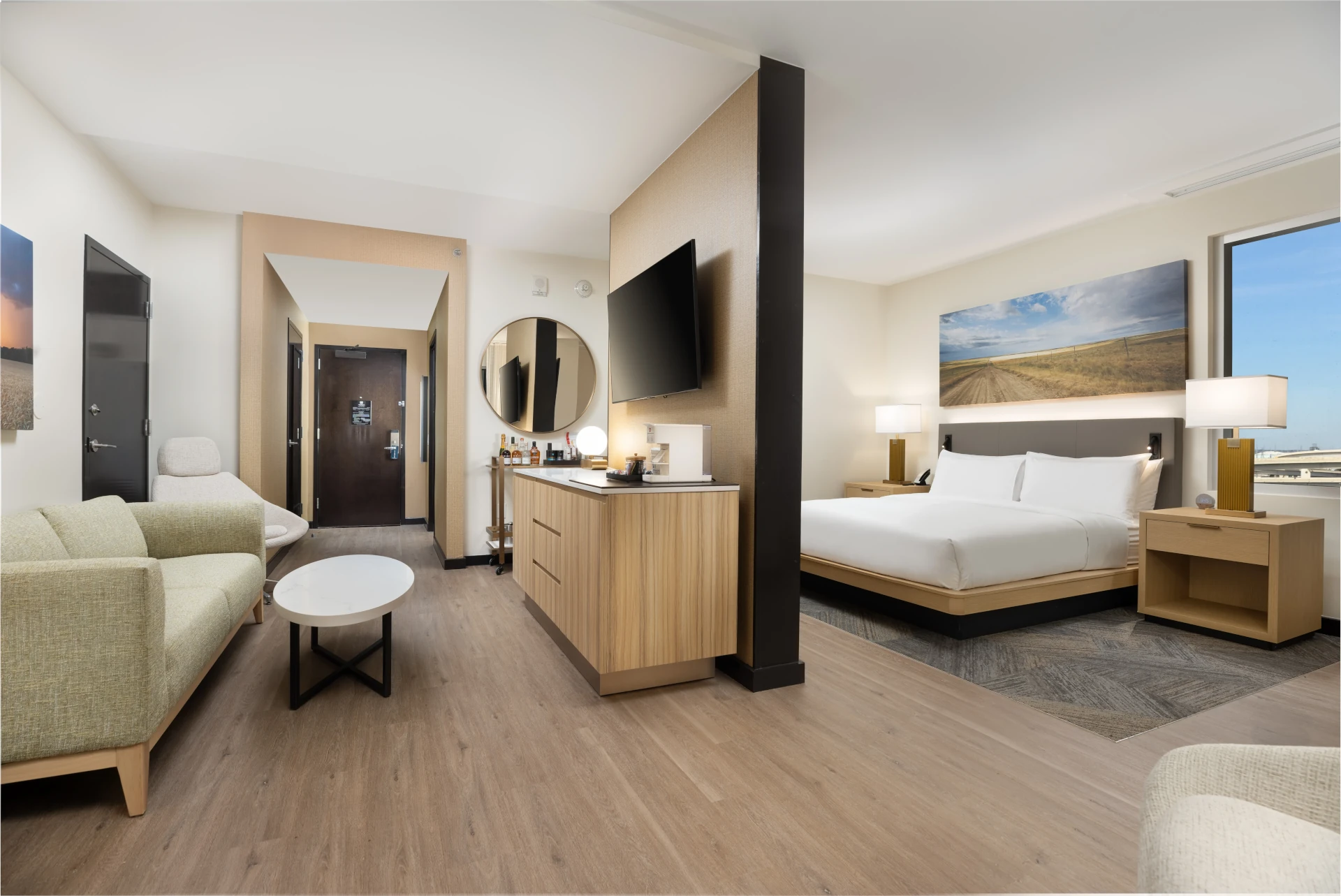 Suite at The Moran Hotel with a sitting area, sofa and a television partition dividing off the bedroom