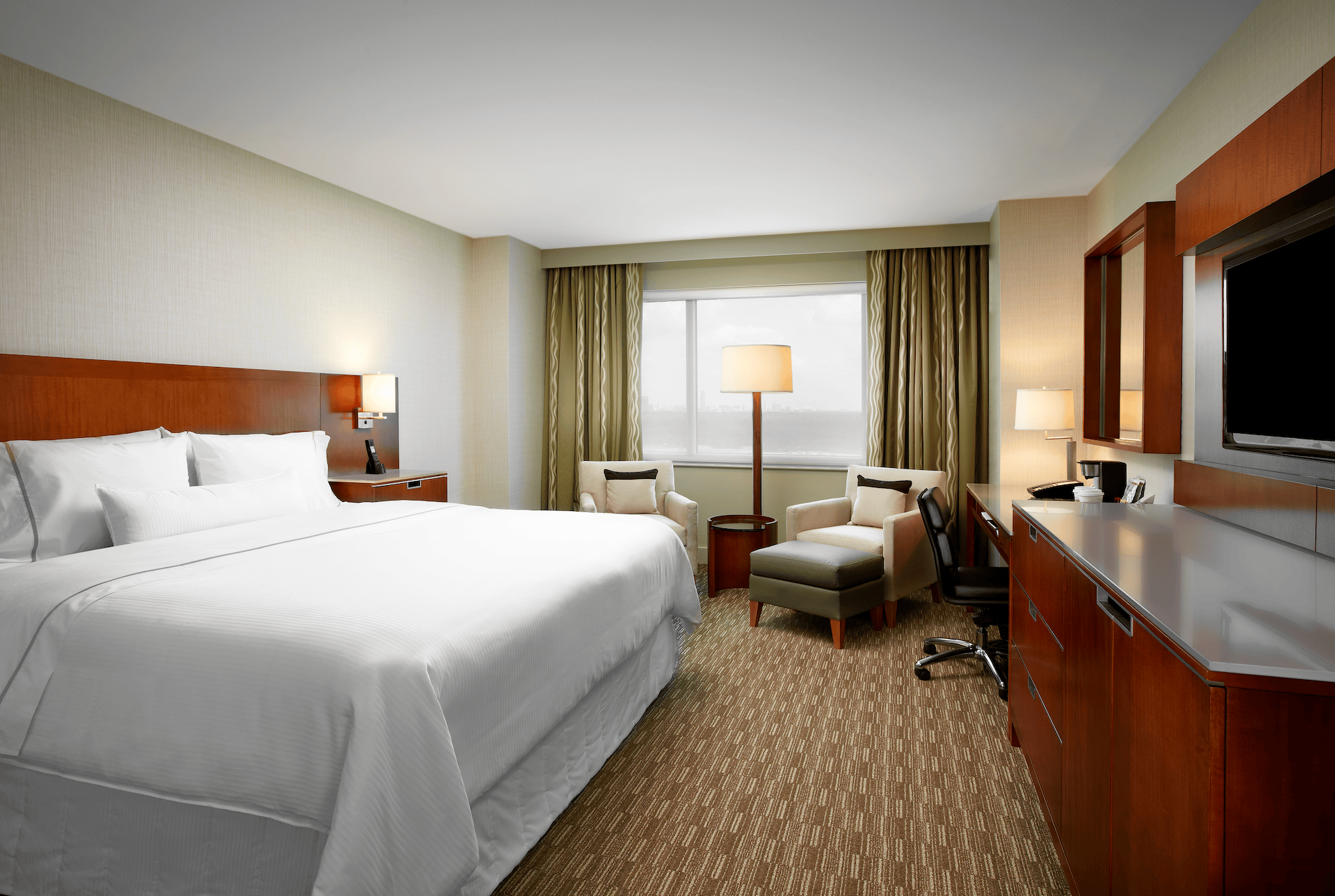 Traditional king guest room at The Westin Memorial, with a king bed, armchair and work desk