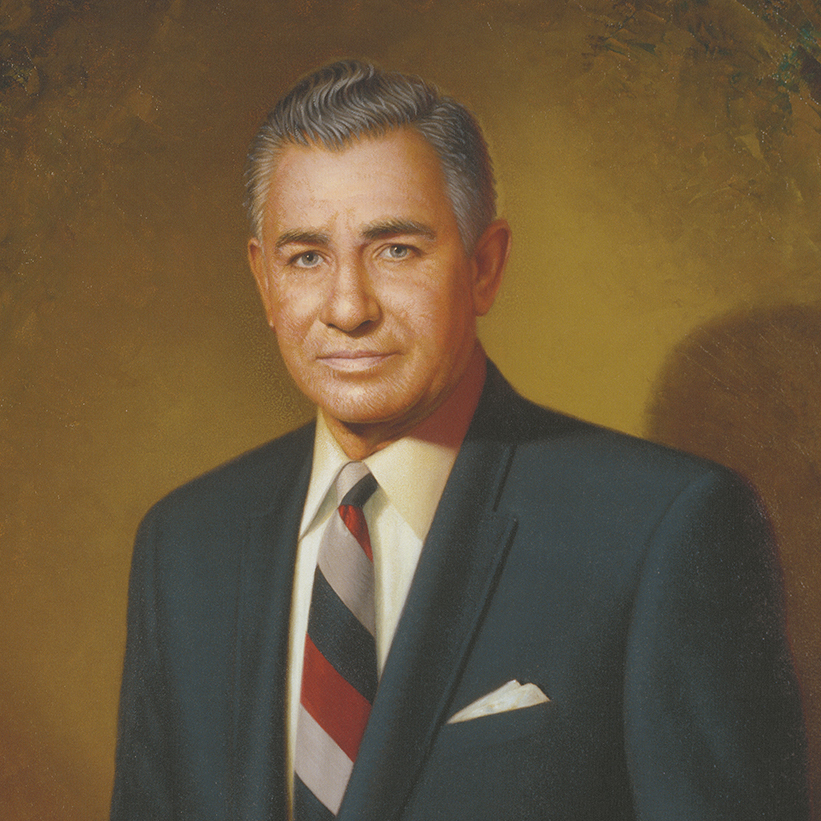 WhyMN-LegacyLeadership Formal painted portrait of a man in a suit, hung at MetroNational