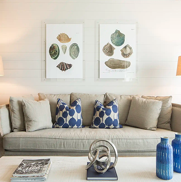 ZaZa-MCITY-Mag7-BeachHouse-COUCH 2 Sofa with blue patterned cushions beneath framed artwork at the Hotel ZaZa Memorial beach house suite