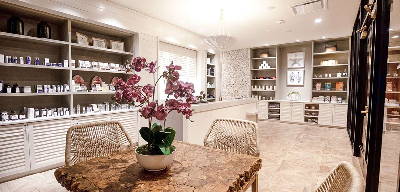 Relaxation and retail room at ZaSpa in Hotel ZaZa Memorial, with product shelves and orchids
