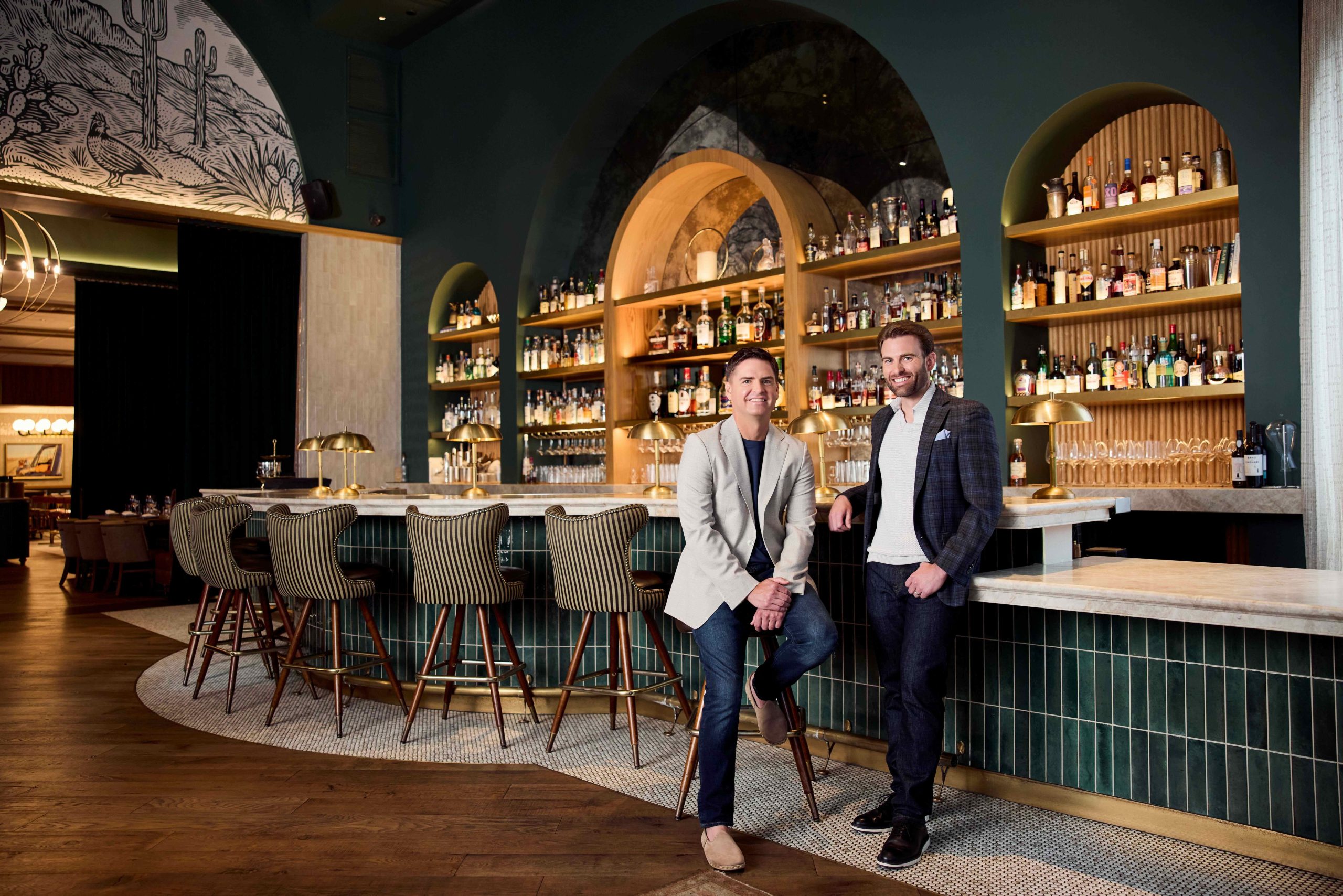 Jason Johnson, Chief Executive Officer, and Scooter Hicks, President of MetroNational, standing in front of a bar